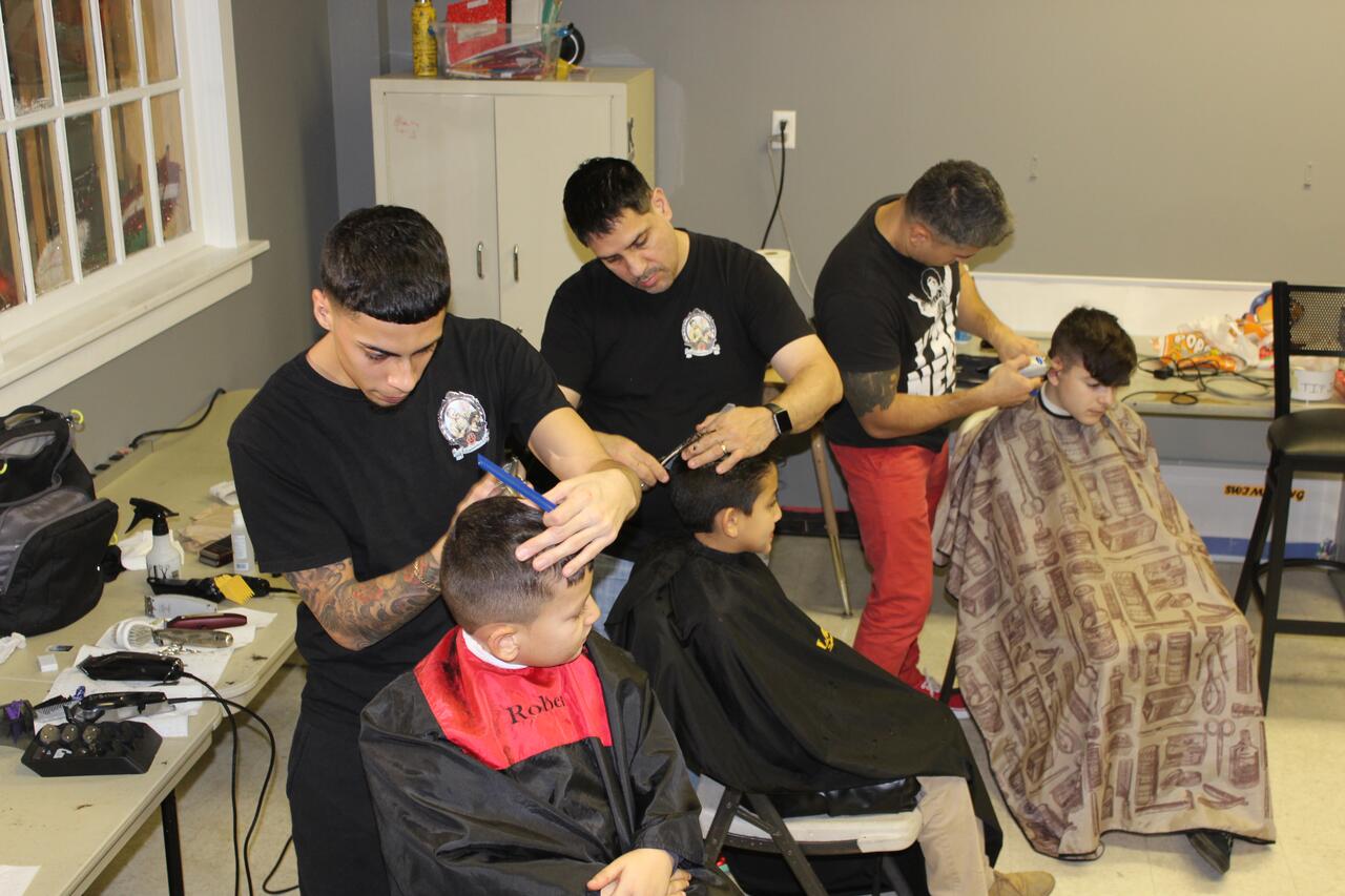 Albion barber cuts hair, supports children in community